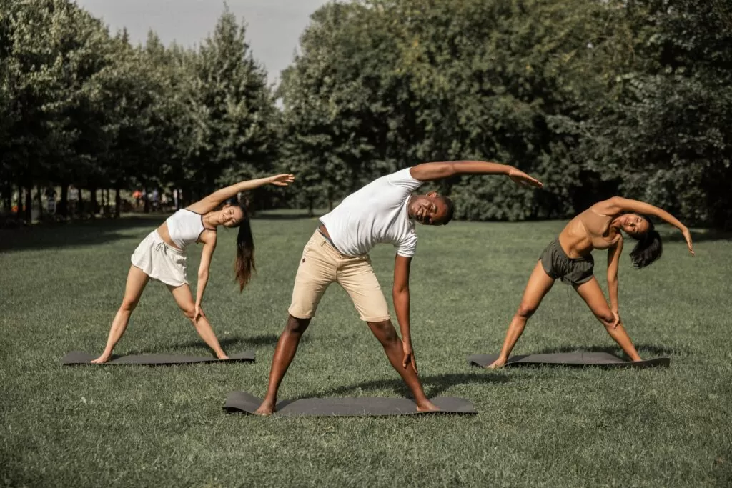 3 People Stretching In Park